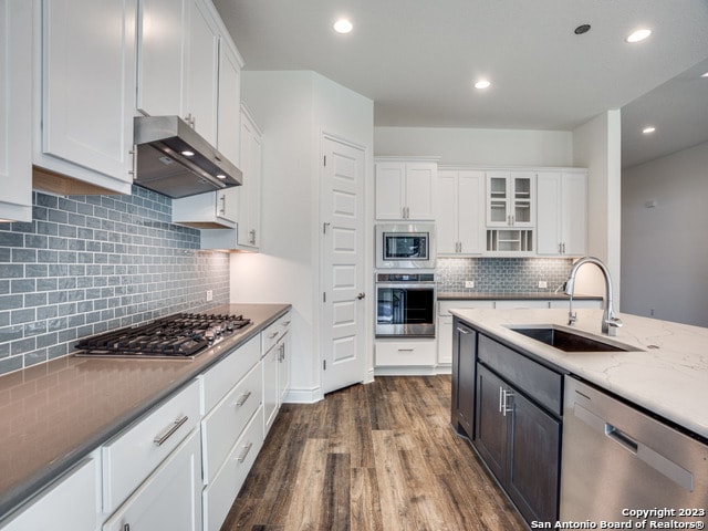 kitchen featuring appliances with stainless steel finishes, white cabinets, sink, and dark hardwood / wood-style flooring