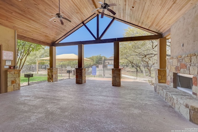 view of patio featuring a gazebo, an outdoor stone fireplace, and ceiling fan