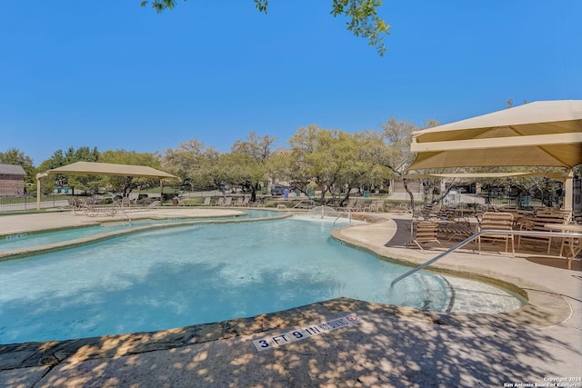 view of swimming pool featuring a patio area