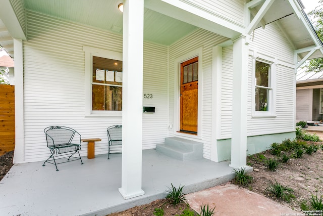 view of exterior entry with covered porch