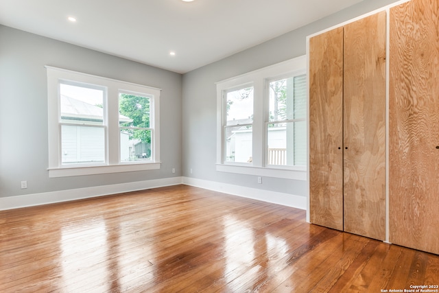 unfurnished bedroom with hardwood / wood-style floors