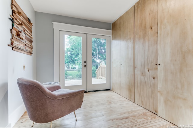 entryway with light hardwood / wood-style floors and french doors