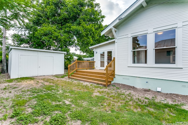 view of yard with a storage shed and a deck