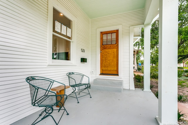 view of exterior entry with covered porch