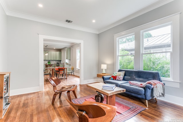 living room with light hardwood / wood-style flooring and ornamental molding