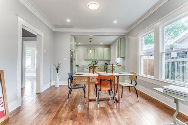 dining area featuring crown molding and hardwood / wood-style floors