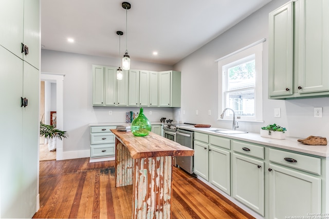 kitchen with pendant lighting, sink, dishwasher, and dark hardwood / wood-style flooring