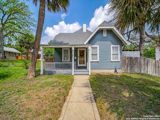 bungalow-style house with a porch and a front lawn