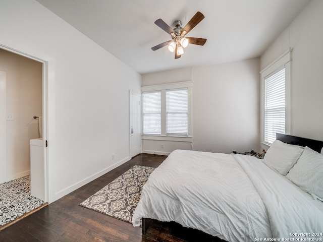 bedroom featuring multiple windows, dark wood-type flooring, and ceiling fan