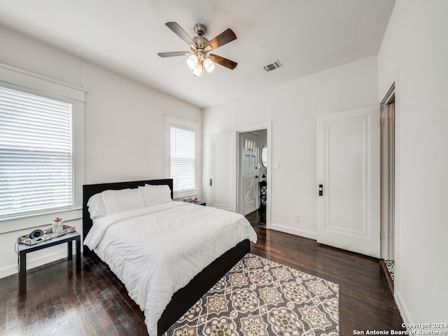 bedroom with ceiling fan and dark hardwood / wood-style flooring