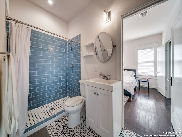 bathroom featuring vanity, toilet, wood-type flooring, and walk in shower