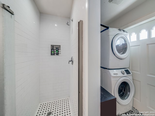 washroom featuring tile patterned floors and stacked washer and clothes dryer