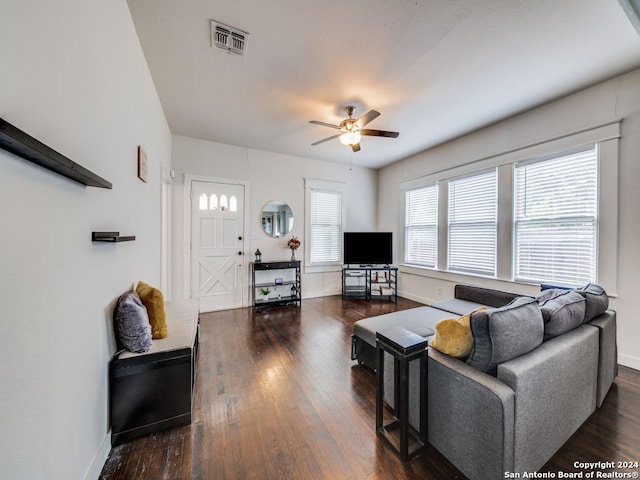 living room with ceiling fan and dark hardwood / wood-style flooring