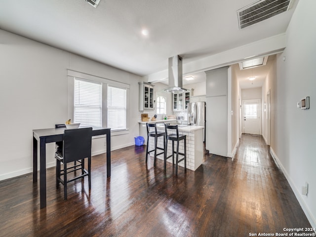 dining area featuring dark hardwood / wood-style flooring and a wealth of natural light