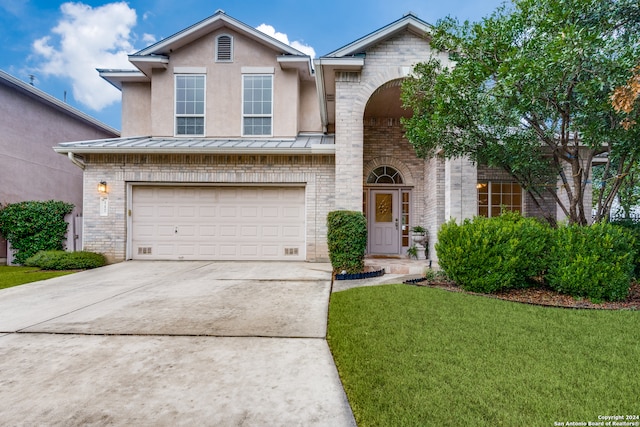 view of front of property with a front yard and a garage