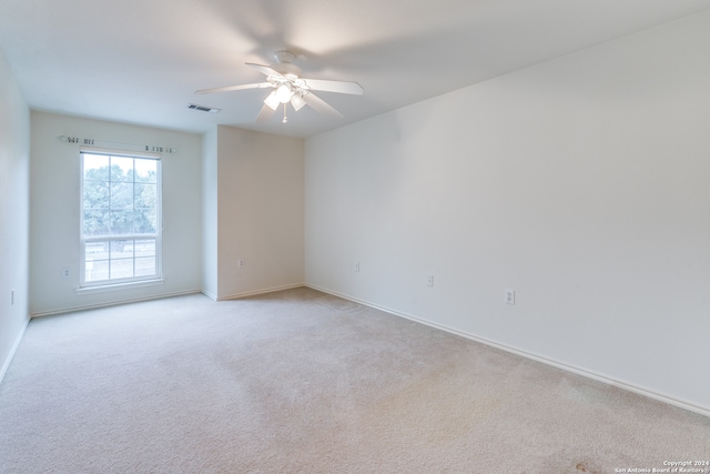 unfurnished room featuring light carpet and ceiling fan