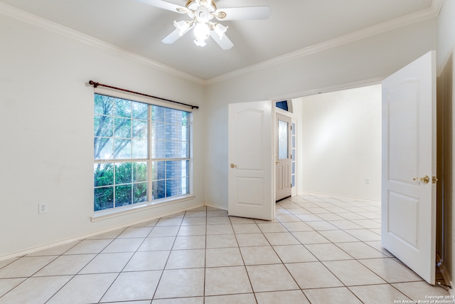 tiled spare room featuring ceiling fan and crown molding