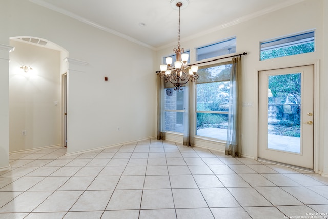 spare room with a notable chandelier, light tile patterned flooring, and crown molding