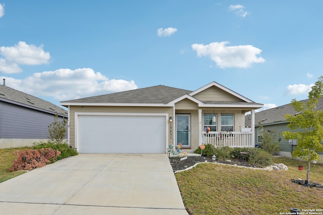 view of front of house featuring a front yard, a porch, and a garage