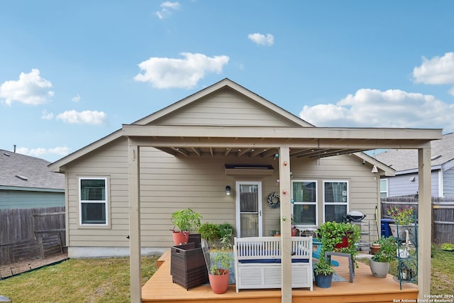 back of house featuring a wooden deck