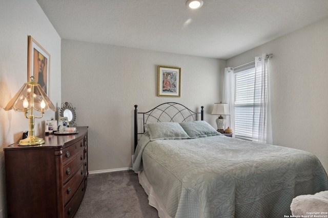 bedroom featuring dark carpet