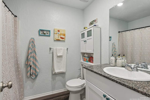 bathroom with vanity, hardwood / wood-style floors, and toilet