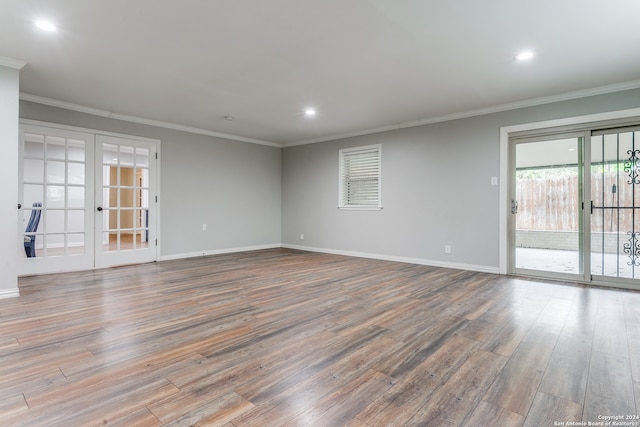 spare room with french doors, crown molding, and hardwood / wood-style flooring