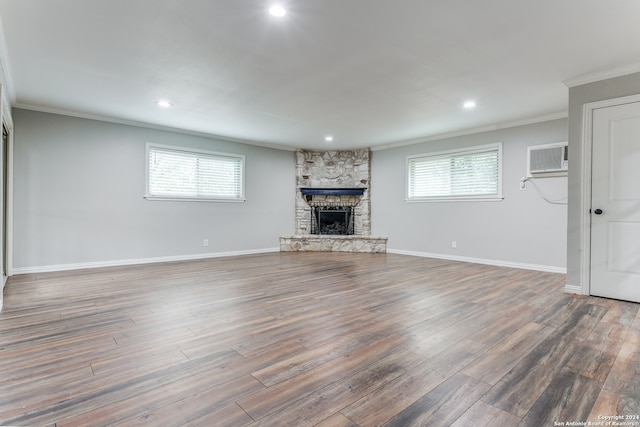 unfurnished living room featuring a healthy amount of sunlight, a fireplace, and dark hardwood / wood-style floors