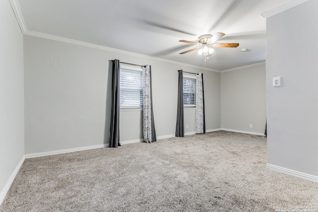 carpeted spare room with crown molding and ceiling fan