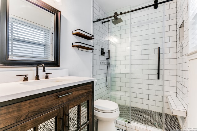 bathroom with vanity, a shower with shower door, and toilet