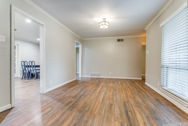 unfurnished room with crown molding and dark wood-type flooring