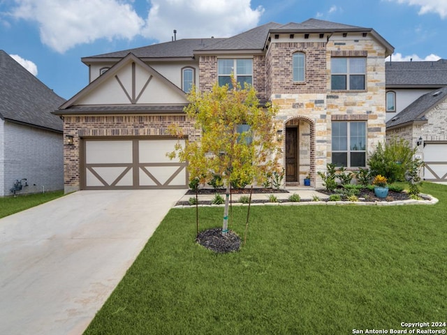 view of front of house with concrete driveway, a front yard, brick siding, and stucco siding