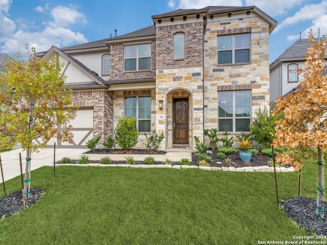 view of front of property featuring a front lawn, concrete driveway, stone siding, stucco siding, and brick siding