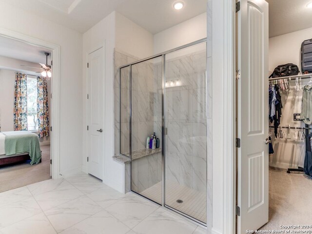 full bath with ensuite bathroom, a marble finish shower, ceiling fan, marble finish flooring, and a spacious closet