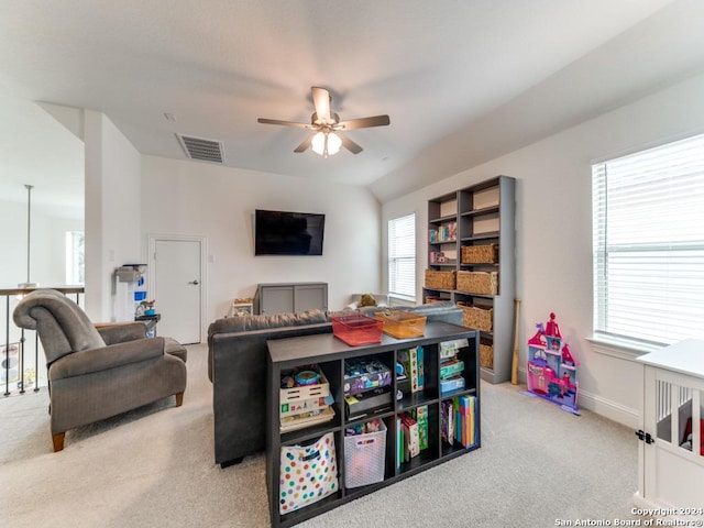 recreation room with carpet floors, ceiling fan, and baseboards
