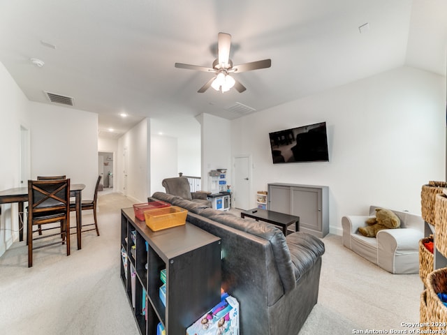 carpeted living room featuring ceiling fan and lofted ceiling