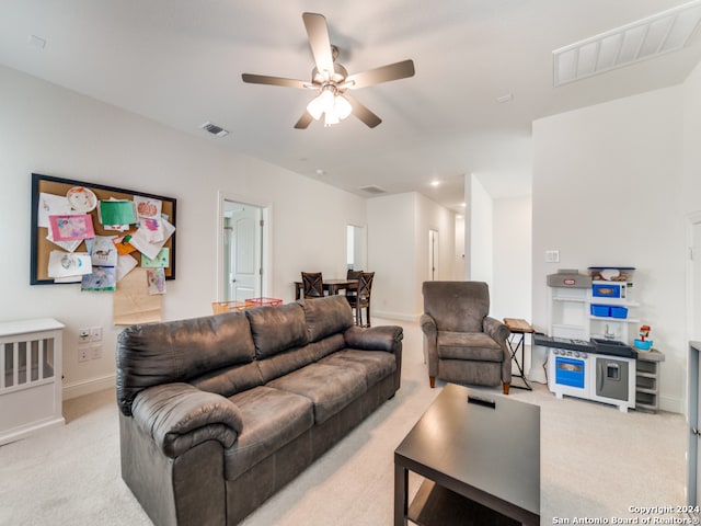 living room featuring ceiling fan and light carpet