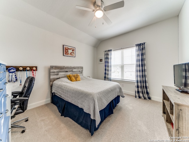 bedroom with vaulted ceiling, light carpet, and ceiling fan