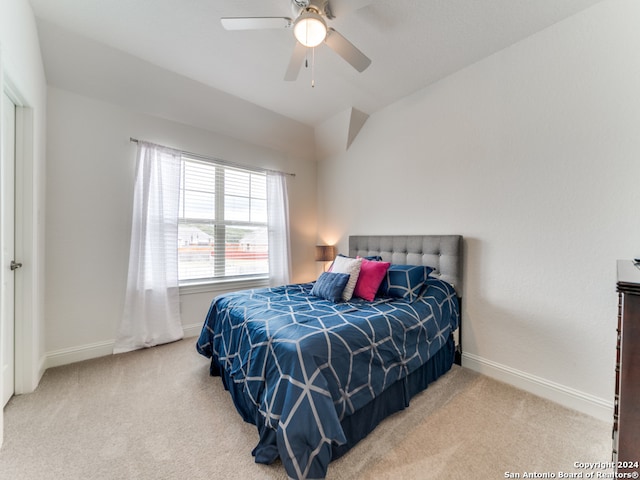 carpeted bedroom featuring lofted ceiling and ceiling fan