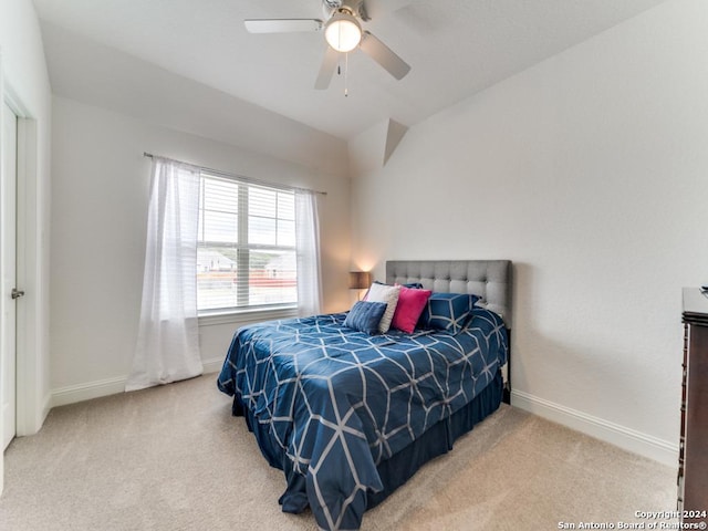 carpeted bedroom with baseboards, lofted ceiling, and a ceiling fan