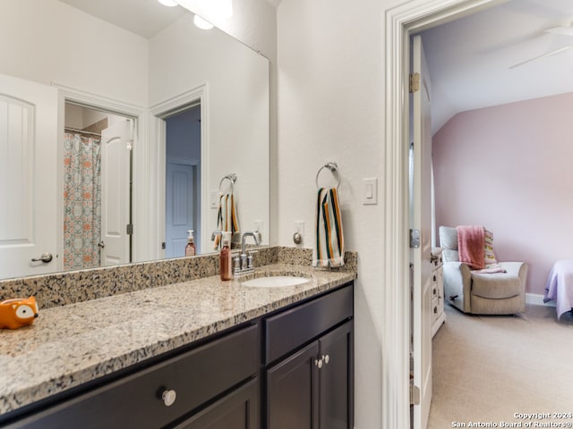 bathroom with vanity, ceiling fan, and lofted ceiling