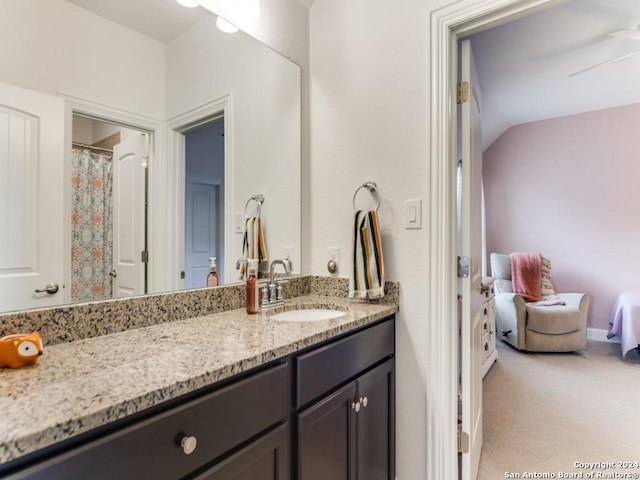 bathroom with vanity and vaulted ceiling