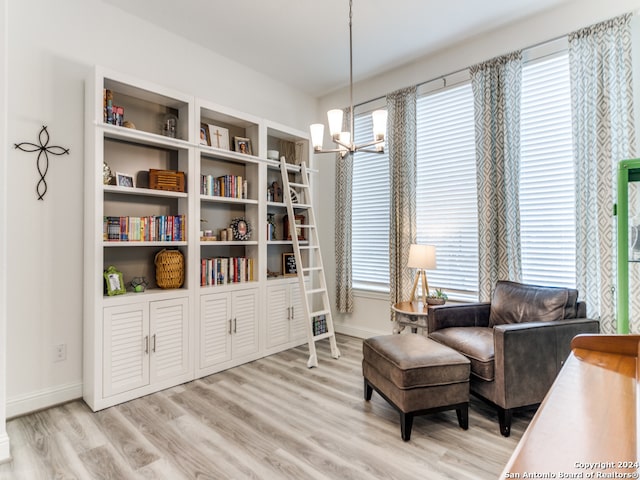 sitting room with light hardwood / wood-style floors and a notable chandelier