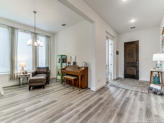 foyer featuring an inviting chandelier and light wood-type flooring