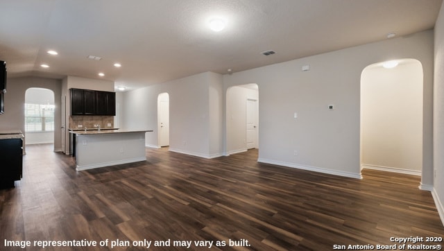 unfurnished living room with dark wood-type flooring