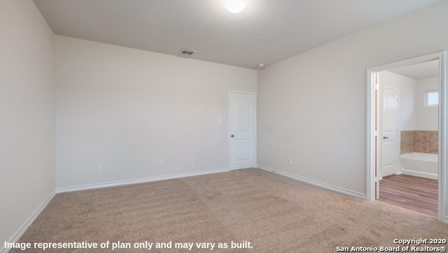 unfurnished room featuring light colored carpet