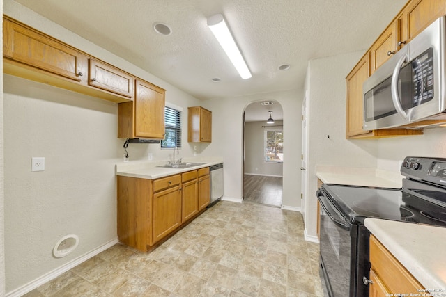 kitchen featuring sink, appliances with stainless steel finishes, and a textured ceiling