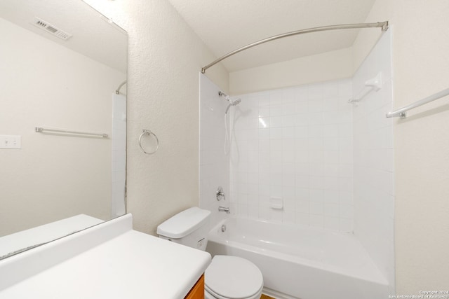 full bathroom with vanity, tiled shower / bath, and toilet