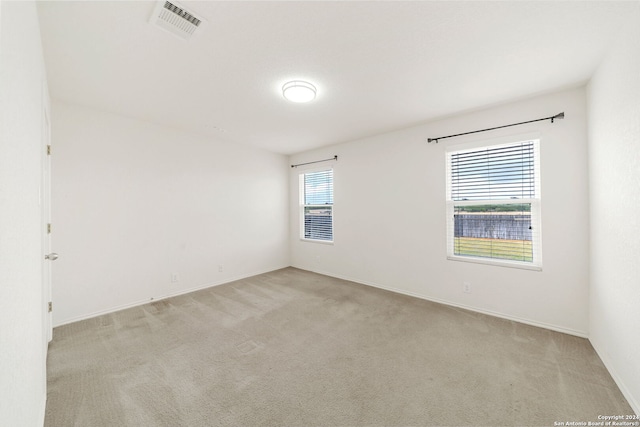 spare room with light carpet