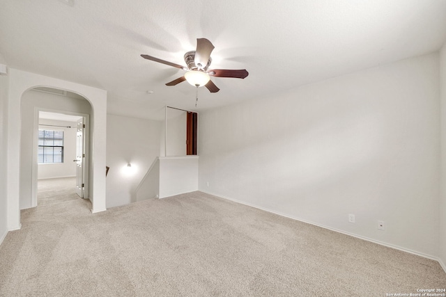 unfurnished room with ceiling fan and light colored carpet